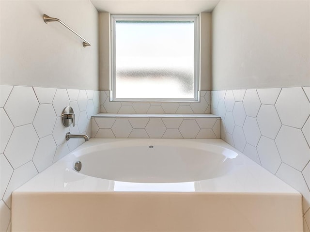 bathroom featuring a tub to relax in