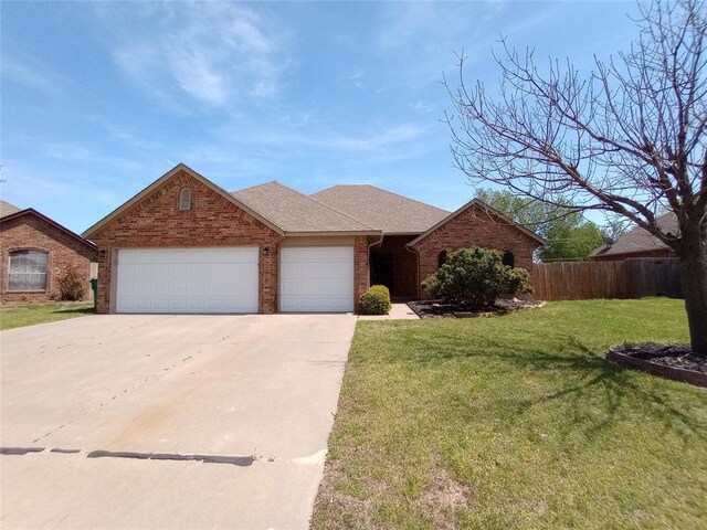 8016 Heather Glen Dr, Yukon, OK 73099 - single story home with a front lawn, driveway, fence, brick siding, and a garage