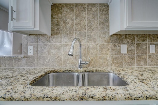 8016 Heather Glen Dr, Yukon, OK 73099 - interior details with light stone countertops, a sink, white cabinetry, and tasteful backsplash