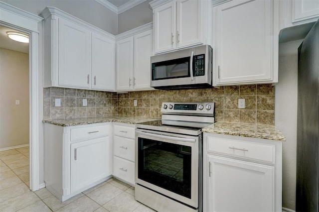 8016 Heather Glen Dr, Yukon, OK 73099 - kitchen featuring white cabinets, appliances with stainless steel finishes, decorative backsplash, and light tile patterned floors