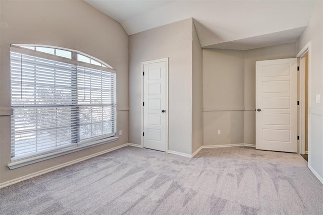 8016 Heather Glen Dr, Yukon, OK 73099 - unfurnished bedroom with lofted ceiling, baseboards, and carpet floors