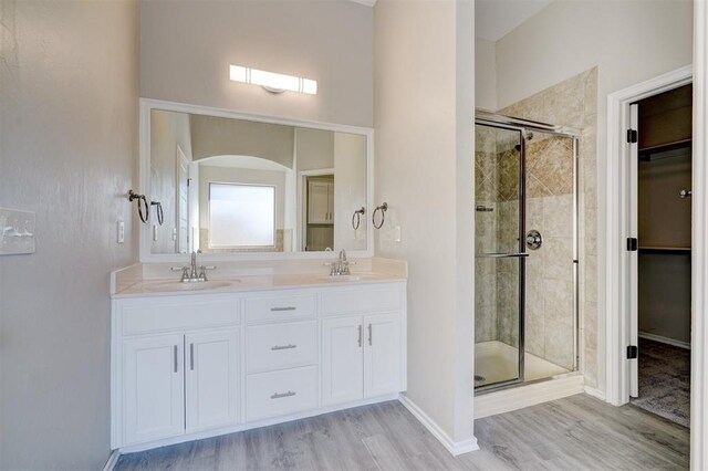 8016 Heather Glen Dr, Yukon, OK 73099 - bathroom featuring a shower stall, wood finished floors, and a sink