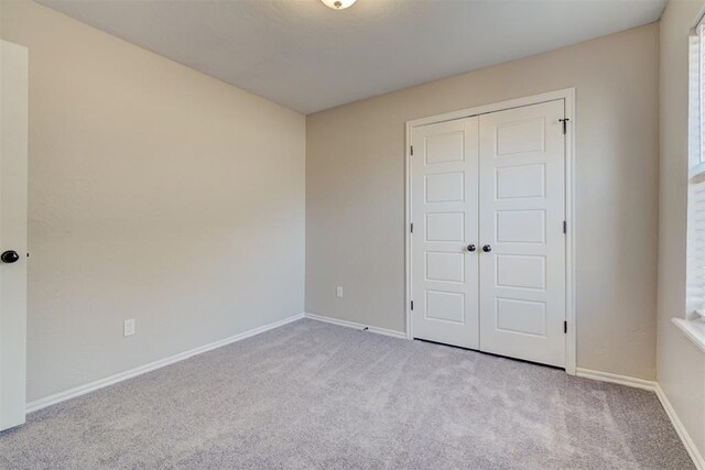8016 Heather Glen Dr, Yukon, OK 73099 - unfurnished bedroom with baseboards, carpet flooring, and a closet