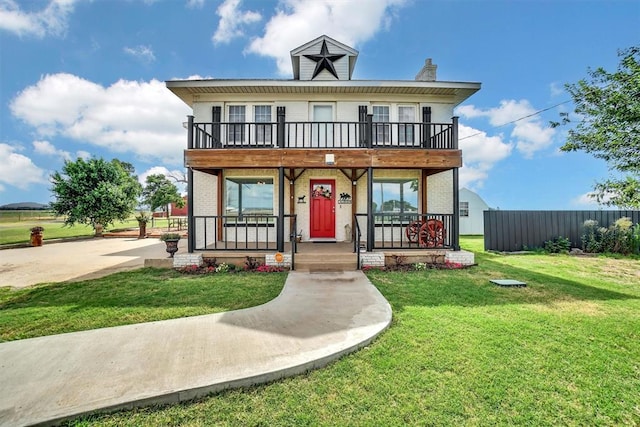 view of front of house featuring covered porch and a front lawn