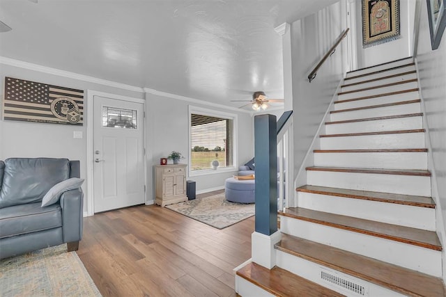 interior space with hardwood / wood-style floors, crown molding, and ceiling fan