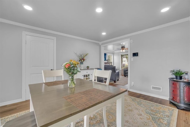 dining room featuring ornamental molding, hardwood / wood-style flooring, and ceiling fan