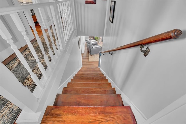 stairs featuring hardwood / wood-style flooring