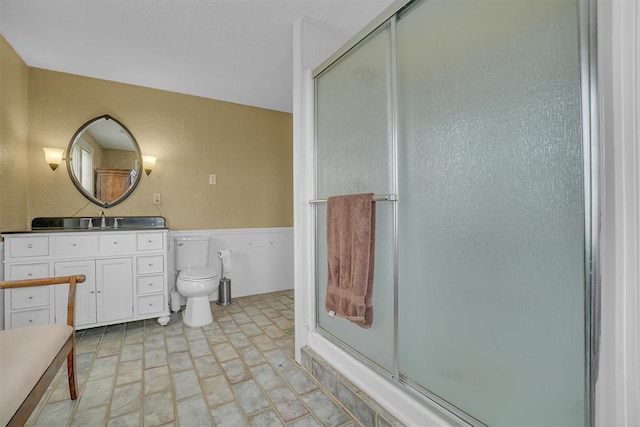 bathroom with vanity, toilet, and walk in shower