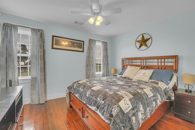 bedroom with ceiling fan and dark hardwood / wood-style floors