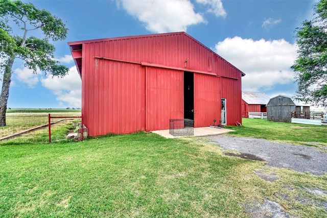 view of outbuilding with a lawn