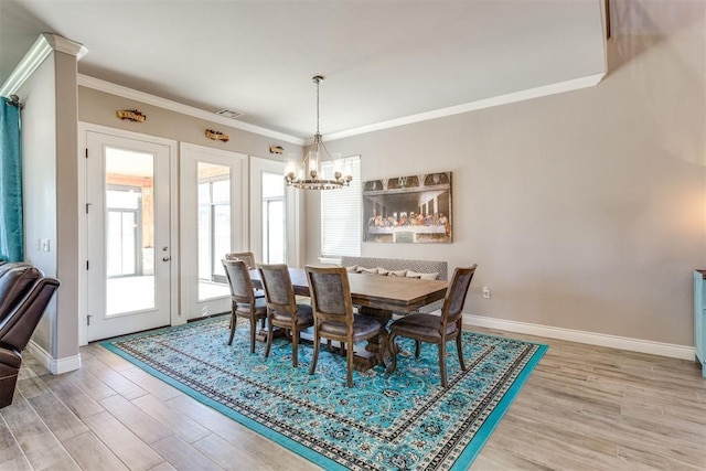 3910 Sienna Rdg, Newcastle, OK 73065 - dining area featuring baseboards, ornamental molding, wood finished floors, and a notable chandelier