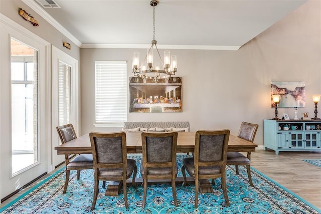 3910 Sienna Rdg, Newcastle, OK 73065 - dining space with visible vents, a chandelier, crown molding, baseboards, and wood finished floors