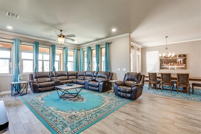 3910 Sienna Rdg, Newcastle, OK 73065 - living room with crown molding, recessed lighting, ceiling fan with notable chandelier, light wood-style floors, and visible vents