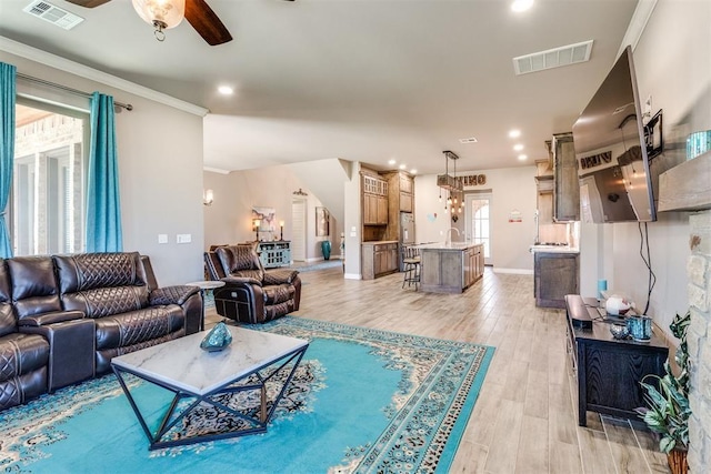 3910 Sienna Rdg, Newcastle, OK 73065 - living room featuring a healthy amount of sunlight, light wood-style floors, ceiling fan, and visible vents