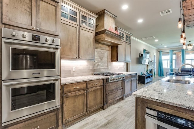 3910 Sienna Rdg, Newcastle, OK 73065 - kitchen featuring tasteful backsplash, a sink, light stone counters, visible vents, and appliances with stainless steel finishes