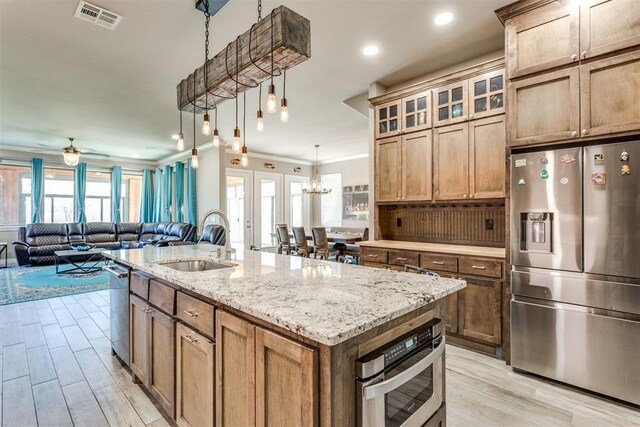 3910 Sienna Rdg, Newcastle, OK 73065 - kitchen with ornamental molding, stainless steel appliances, ceiling fan with notable chandelier, a sink, and visible vents