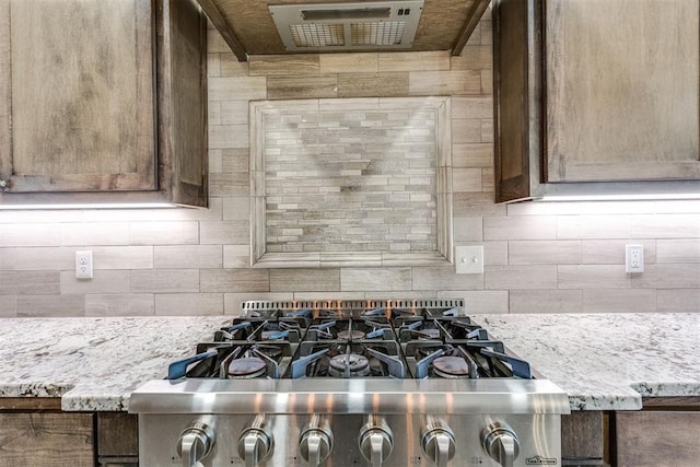 3910 Sienna Rdg, Newcastle, OK 73065 - details featuring backsplash, stove, and light stone counters