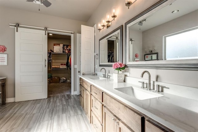 3910 Sienna Rdg, Newcastle, OK 73065 - bathroom featuring double vanity, a walk in closet, ceiling fan, and a sink