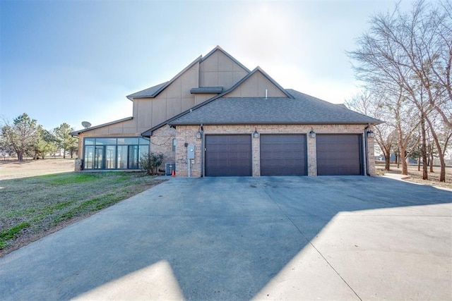 3910 Sienna Rdg, Newcastle, OK 73065 - view of front of house featuring a front yard, roof with shingles, concrete driveway, an attached garage, and brick siding