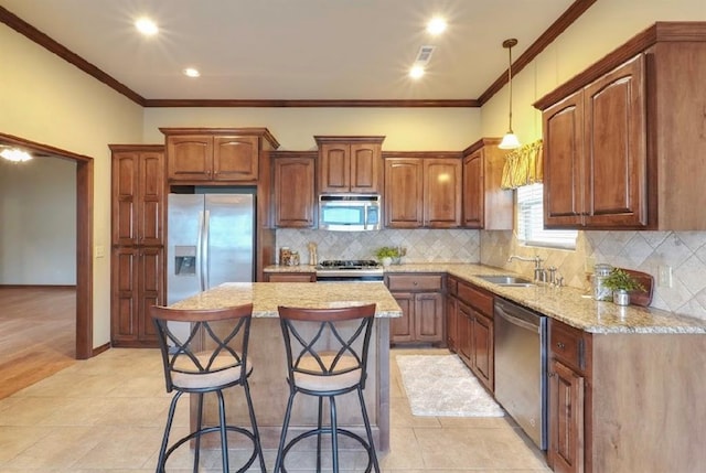 kitchen featuring stainless steel appliances, a center island, sink, crown molding, and decorative backsplash