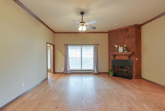 unfurnished living room with ceiling fan, ornamental molding, a large fireplace, and light hardwood / wood-style floors