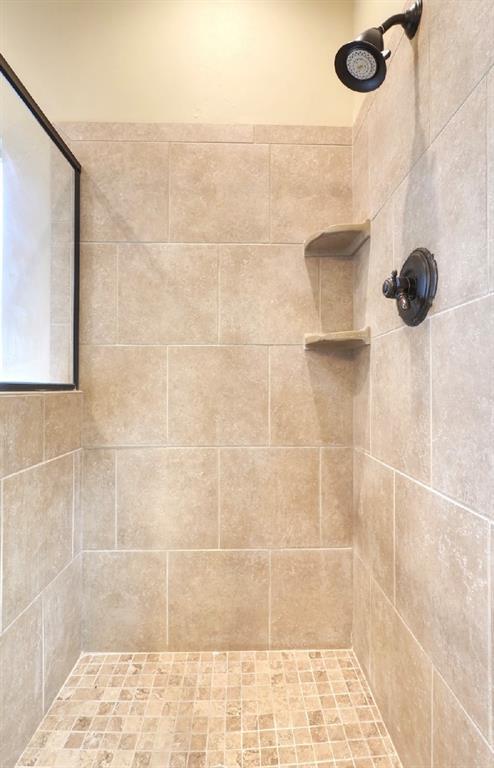 bathroom with a tile shower