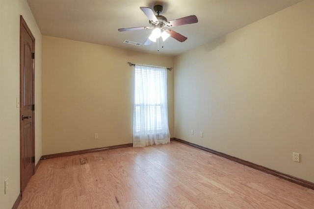 spare room featuring light wood-type flooring and ceiling fan