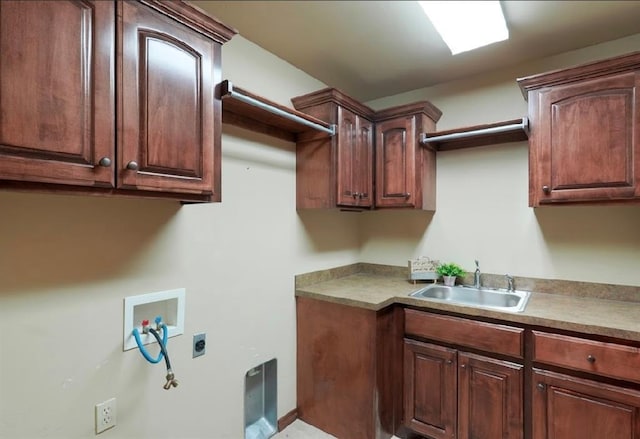 laundry area with sink, washer hookup, hookup for an electric dryer, and cabinets