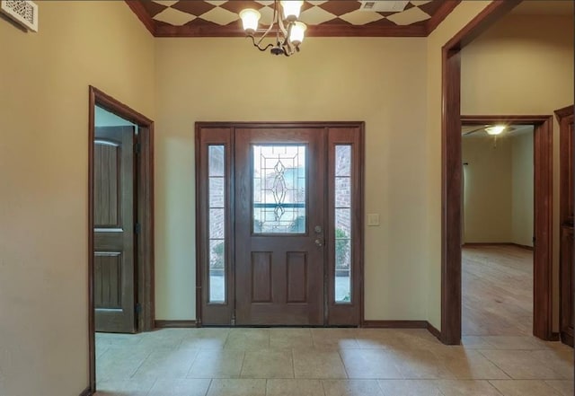 entrance foyer with a notable chandelier and ornamental molding