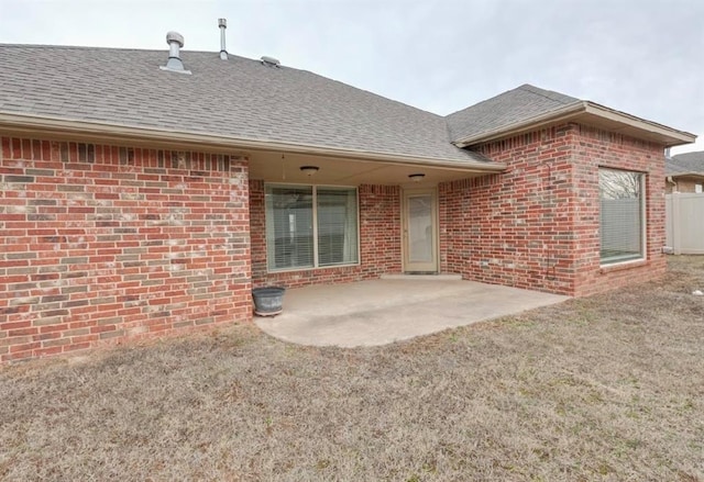 back of house featuring a patio and a lawn