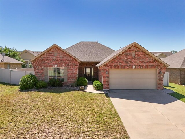 2016 Lantana Cir, Shawnee, OK 74804 - traditional-style house with brick siding, an attached garage, driveway, and roof with shingles