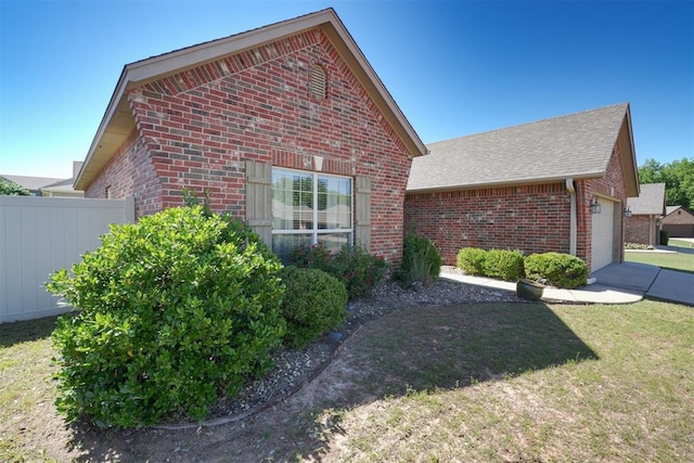 2016 Lantana Cir, Shawnee, OK 74804 - view of side of home featuring brick siding, a shingled roof, and a garage