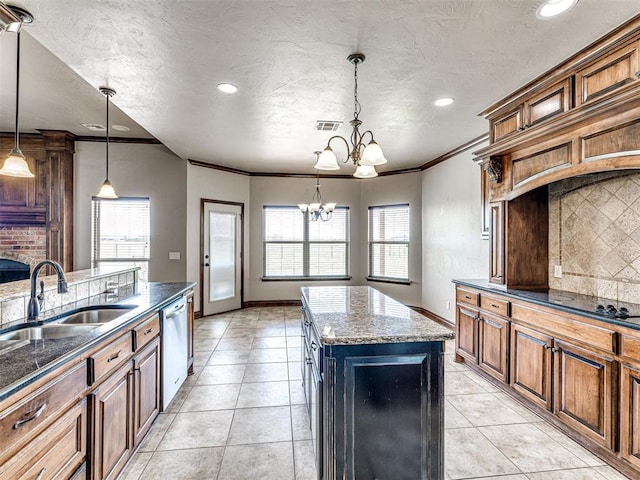 kitchen with a chandelier, sink, pendant lighting, stainless steel dishwasher, and a kitchen island with sink