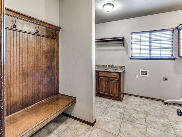 mudroom featuring light tile patterned floors and sink