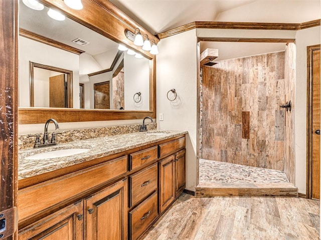 bathroom with vanity and a tile shower