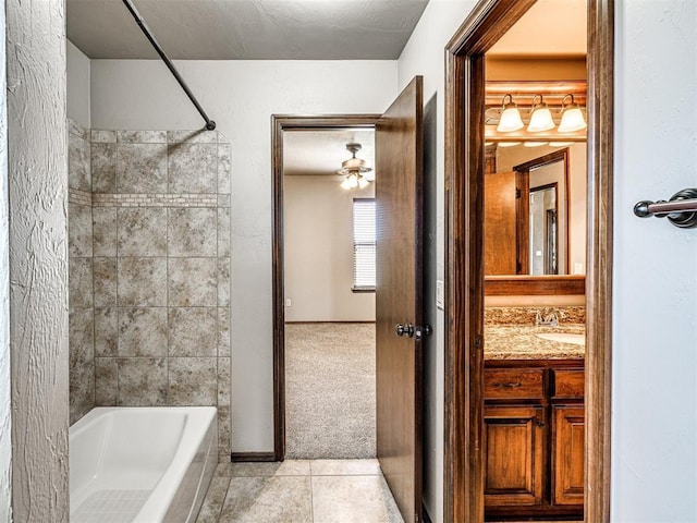 bathroom featuring vanity, tiled shower / bath, and tile patterned floors