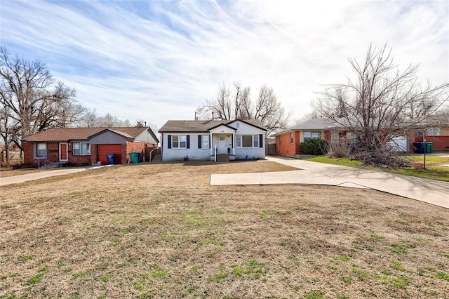 ranch-style home featuring brick siding and a front yard