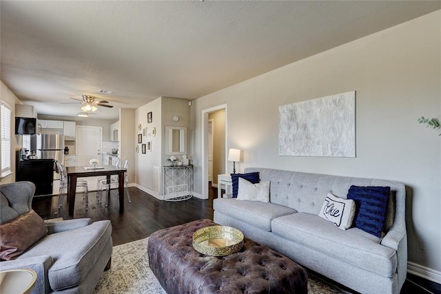 414 NW 50th St, Oklahoma City, OK 73118 - living room with baseboards, dark wood-type flooring, and a ceiling fan