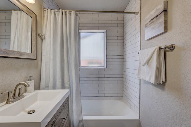 414 NW 50th St, Oklahoma City, OK 73118 - bathroom featuring a textured wall, shower / bath combo with shower curtain, and vanity