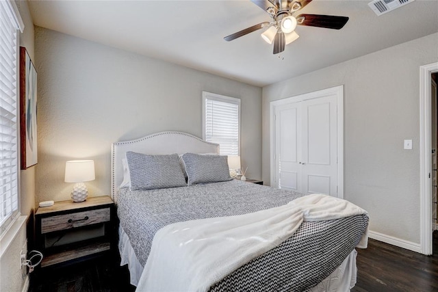 414 NW 50th St, Oklahoma City, OK 73118 - bedroom with dark wood-type flooring, a closet, baseboards, and ceiling fan