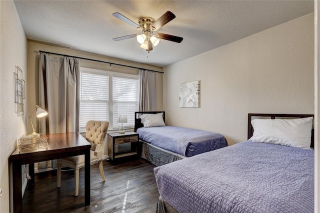 414 NW 50th St, Oklahoma City, OK 73118 - bedroom featuring dark wood-style floors, a ceiling fan, a textured wall, and a textured ceiling