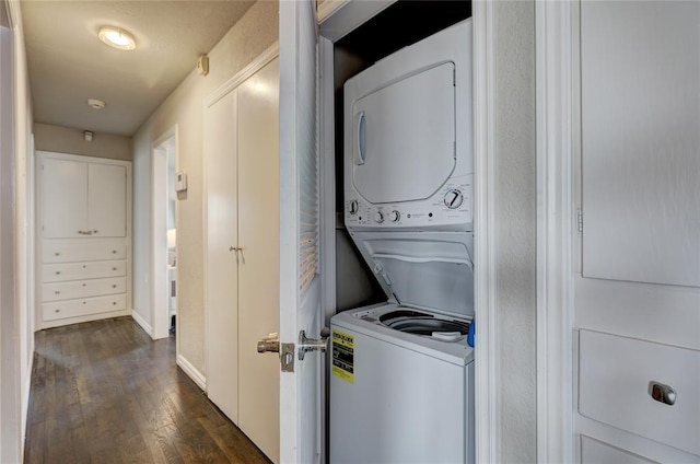 414 NW 50th St, Oklahoma City, OK 73118 - laundry area featuring estacked washer and dryer, dark wood-type flooring, and baseboards