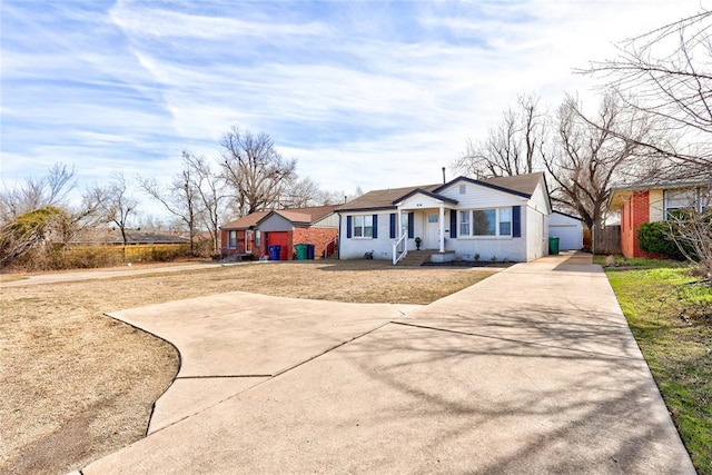414 NW 50th St, Oklahoma City, OK 73118 - view of front of house featuring a front yard, concrete driveway, and a garage