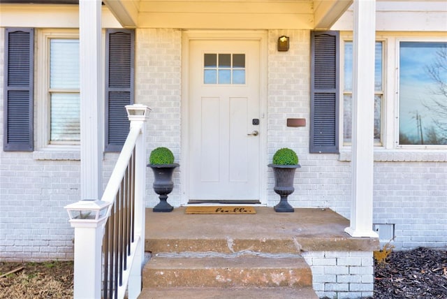 414 NW 50th St, Oklahoma City, OK 73118 - doorway to property featuring brick siding and covered porch