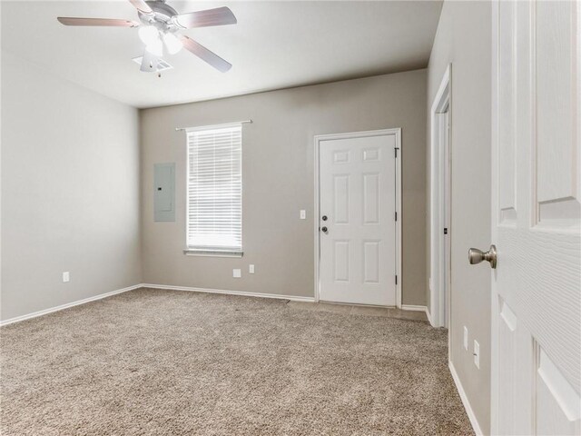 carpeted spare room with electric panel and ceiling fan