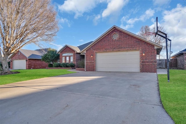 ranch-style home with a garage and a front lawn