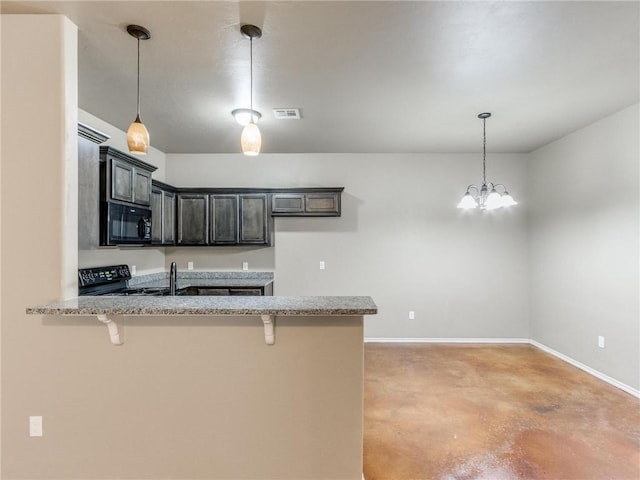 kitchen featuring a breakfast bar area, kitchen peninsula, hanging light fixtures, and black appliances