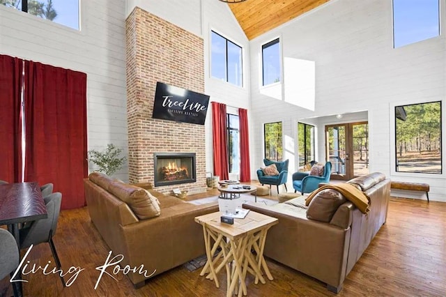 living room featuring wood ceiling, a fireplace, wood finished floors, and french doors