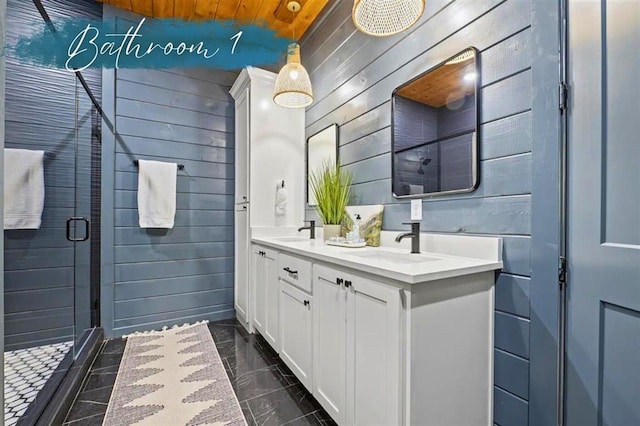 full bath with a stall shower, a sink, wood walls, and double vanity
