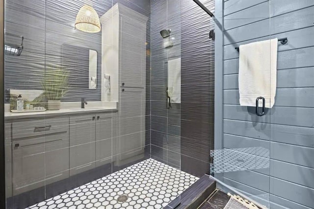 bathroom with a sink and a shower stall